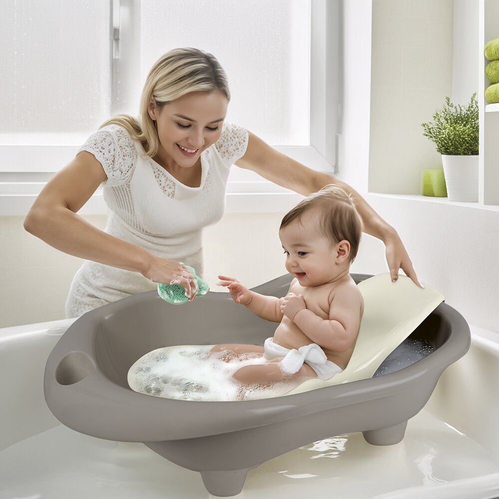 Dolu Nuve Cadita cu suport anatomic Hippo gri designul usor si compact cu dop de scurgere 6 luni+