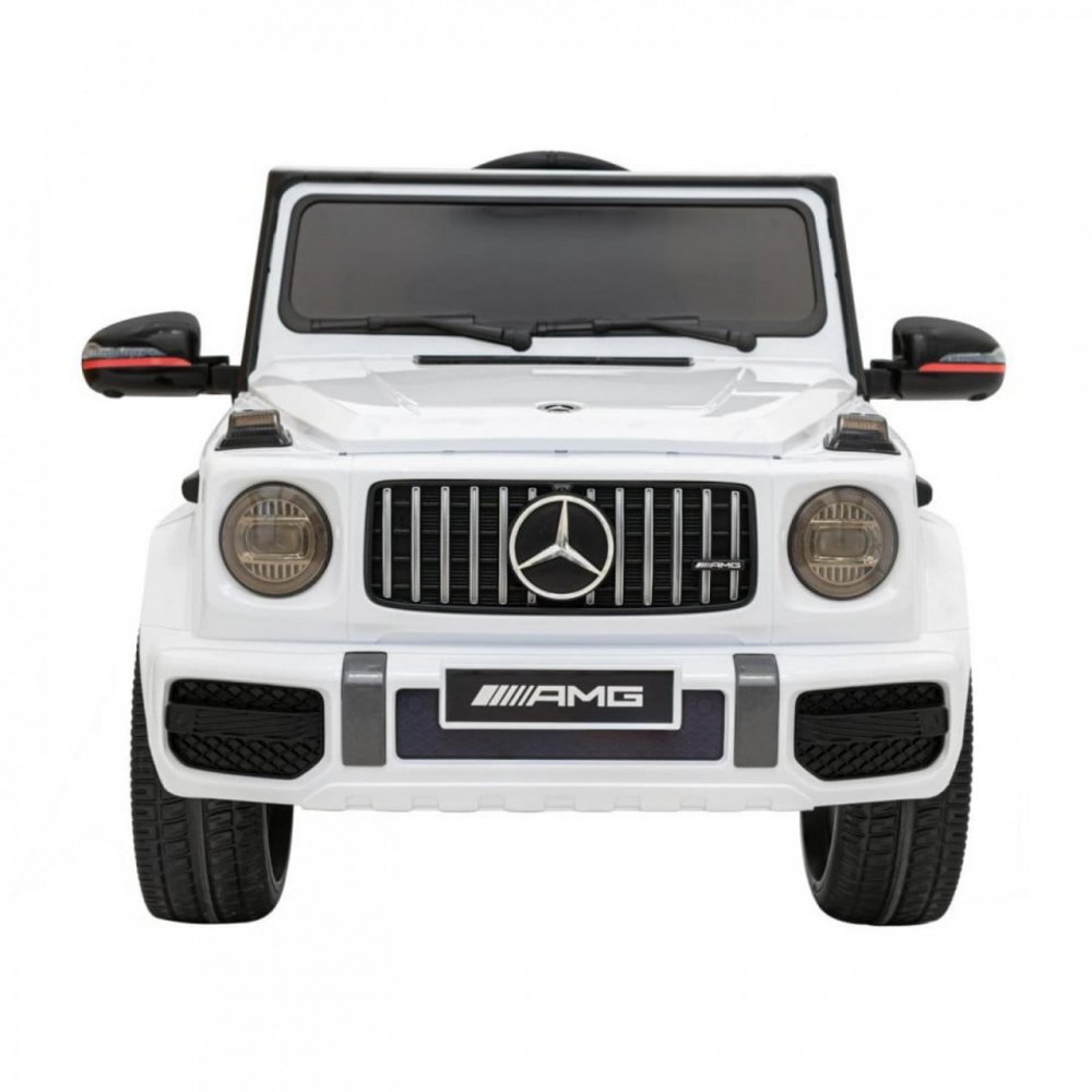 Novokids Masinuta electrica pentru copii Mercedes G63 AMG Alb roti din cauciuc Eva melodii si USB usi cu deschidere 12V 2 viteze lungime 120 cm 2 motoare de 25 W