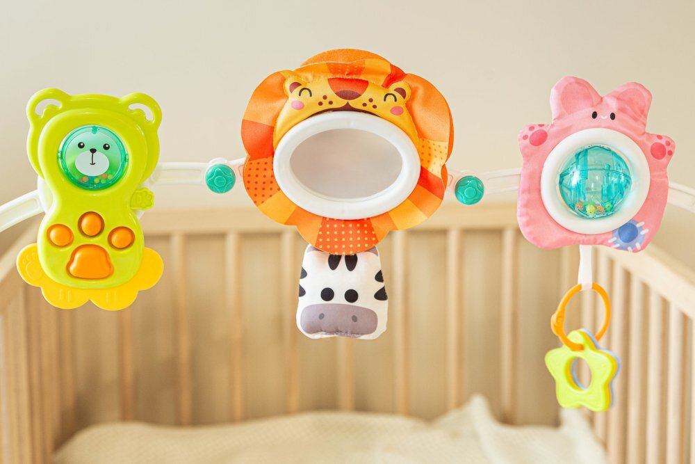 Toyz by Caretero Arcada senzoriala cu jucarii pentru caruciorpatutscaun auto copii Toyz Lion cu zornaitori oglinda si jucarii gingivale prindere universala